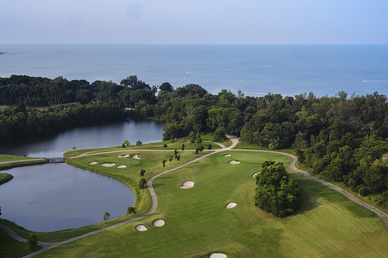 Tropical championship golf course framed by rainforest in Malaysia