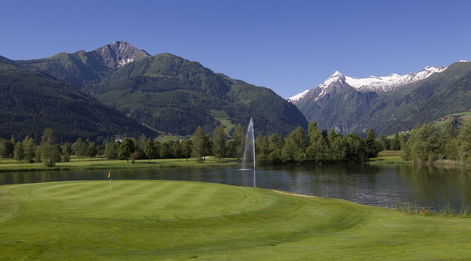 Golfclub Zell am See Kaprun, alpine fairway below the snow capped peaks of the Austrian Alps near the Zeller See