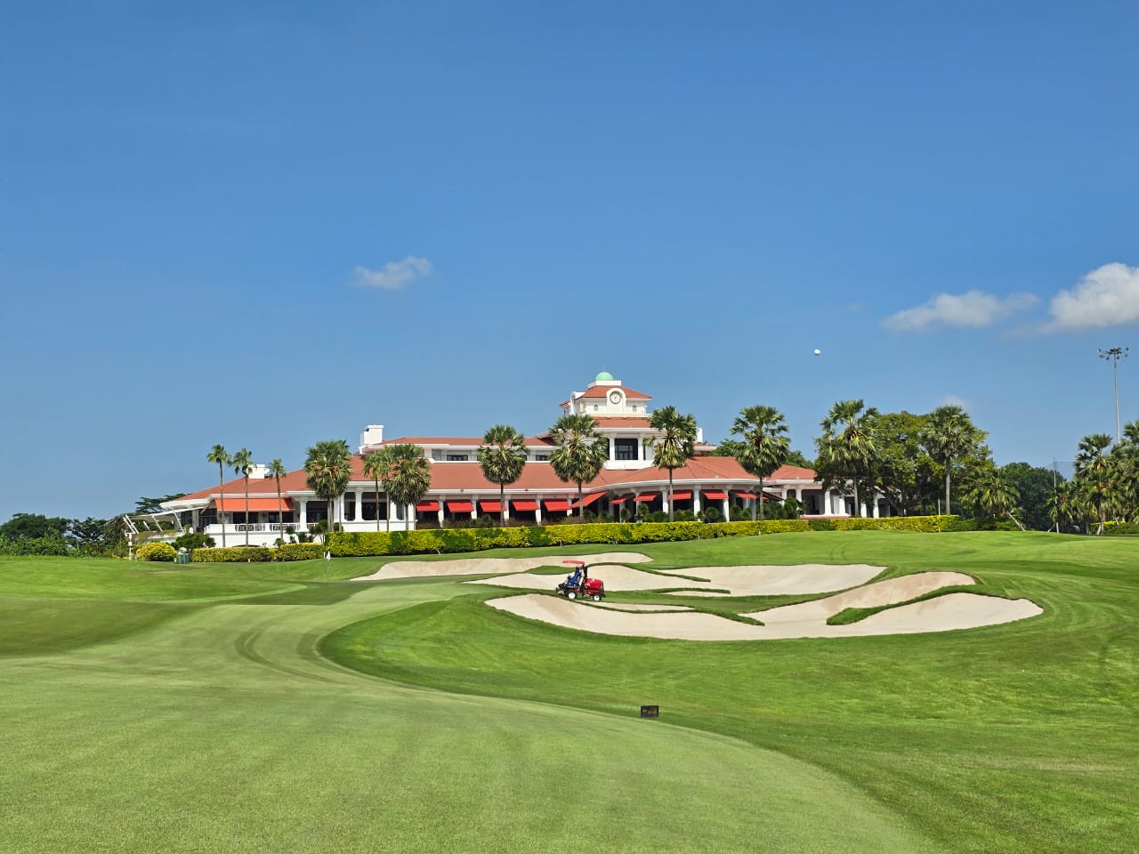 Sentosa Golf Club Tanjong course fairway beside the Singapore Strait with the city skyline