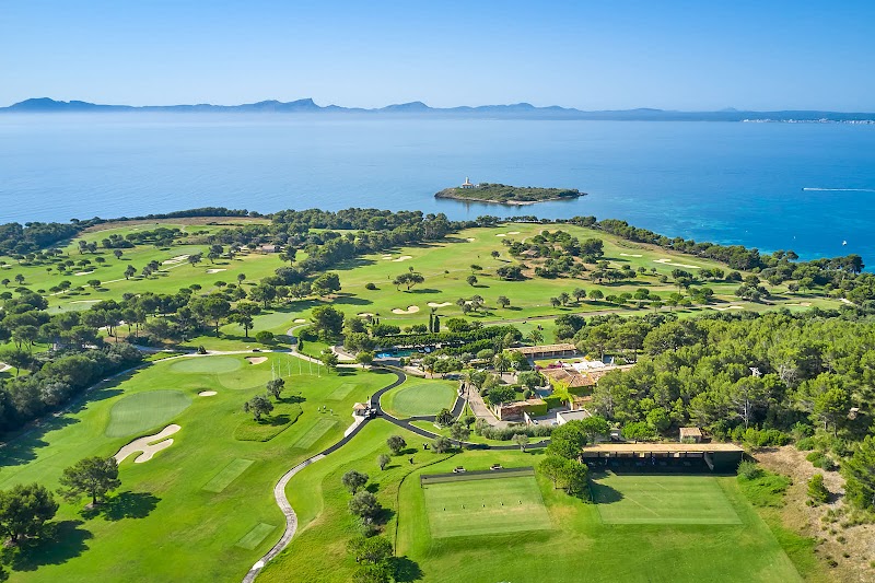 Club de Golf Alcanada with its lighthouse in the bay near Alcudia, Mallorca