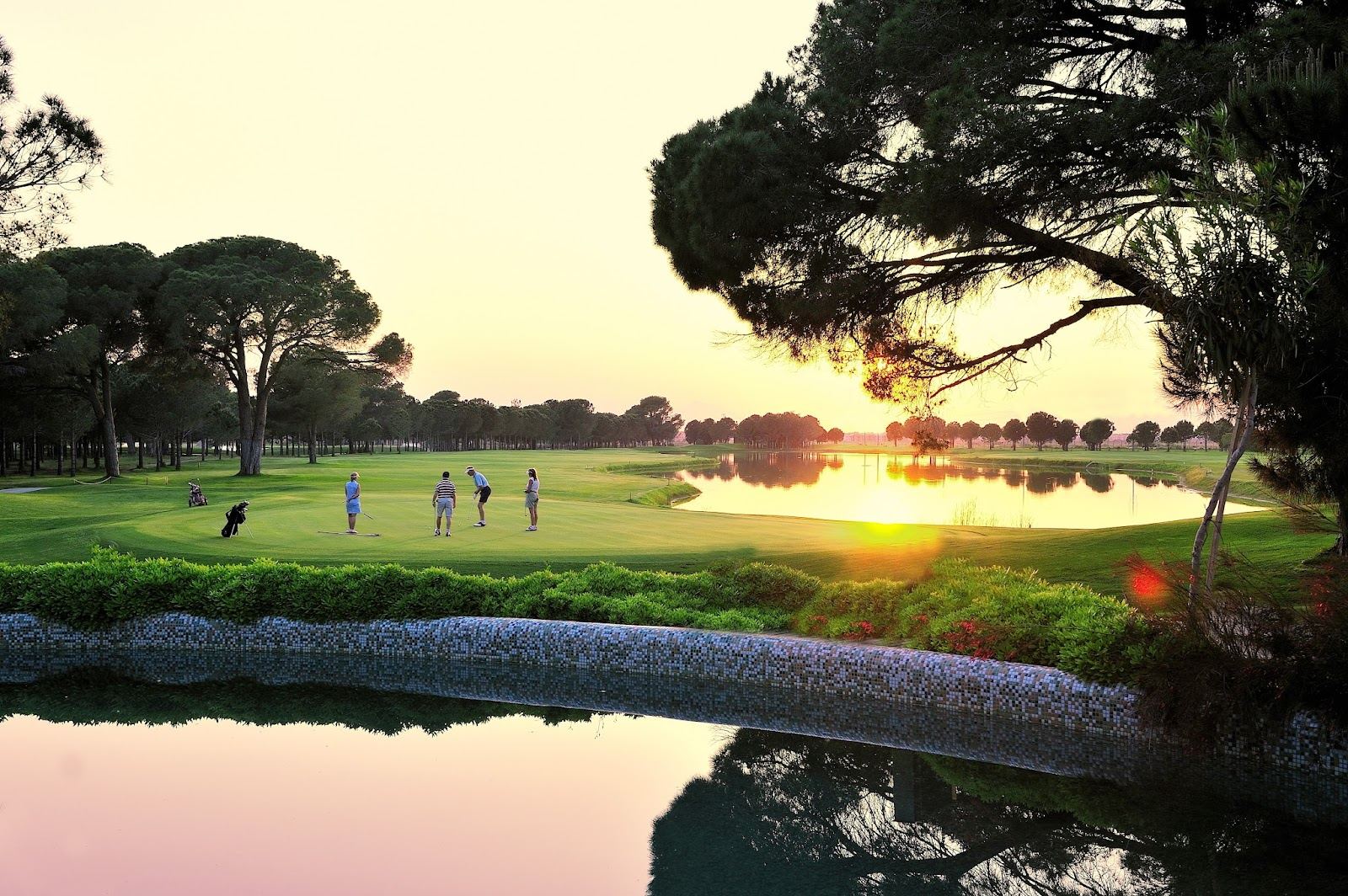 Gloria Old Course fairways winding through mature pine forest with a lake in Belek, Turkey
