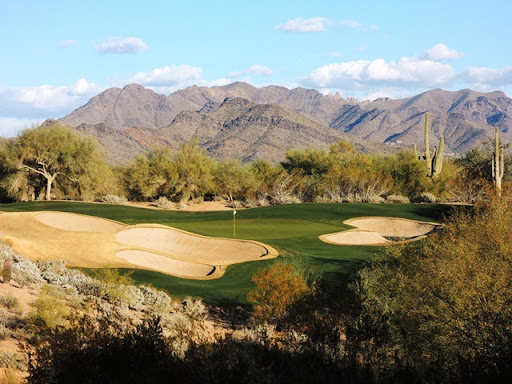 Grayhawk Raptor course, a desert fairway framed by bunkers and saguaro in north Scottsdale, Arizona