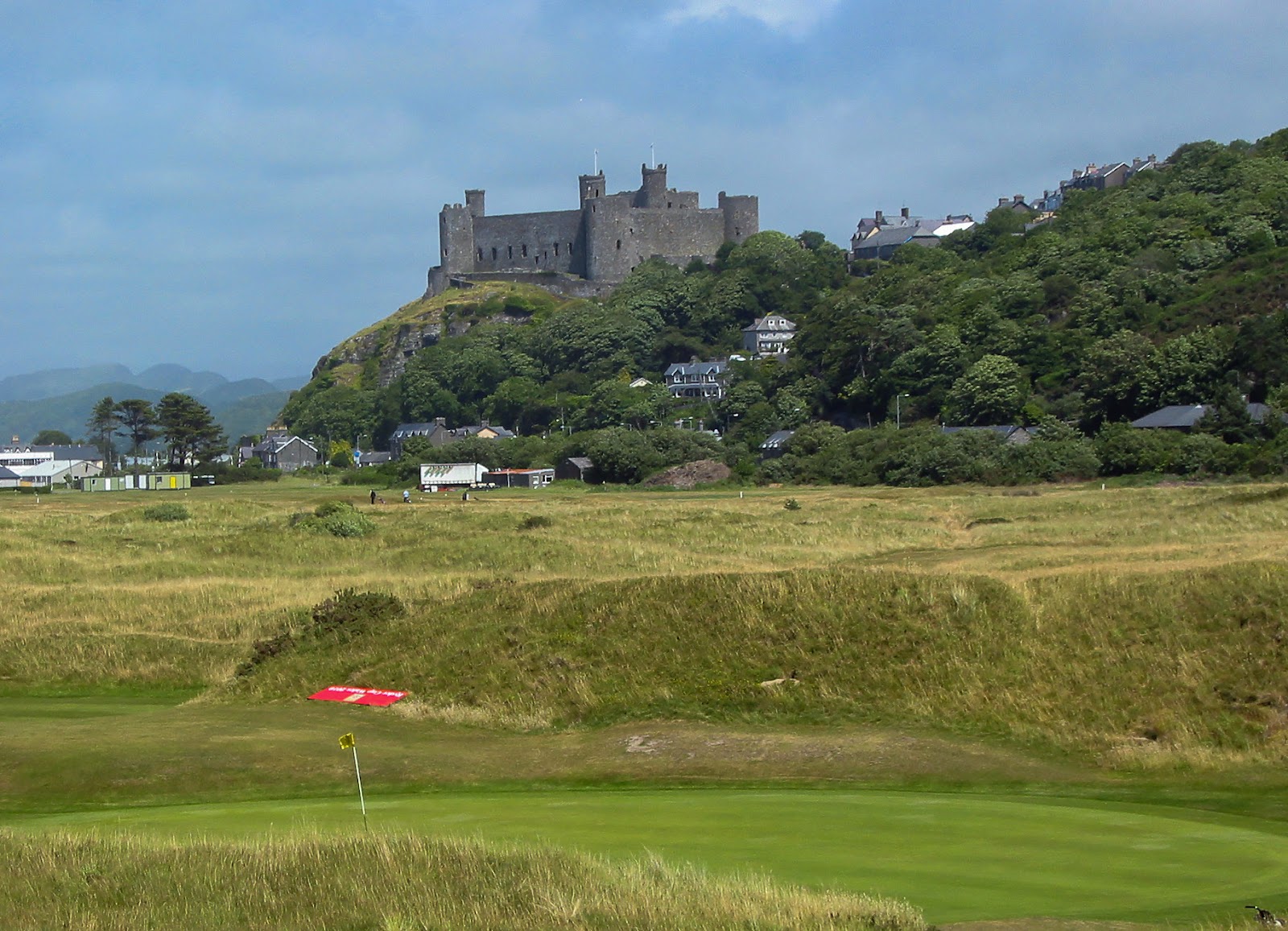Royal St David's Golf Club, links fairways beneath Harlech Castle with the mountains of Snowdonia behind