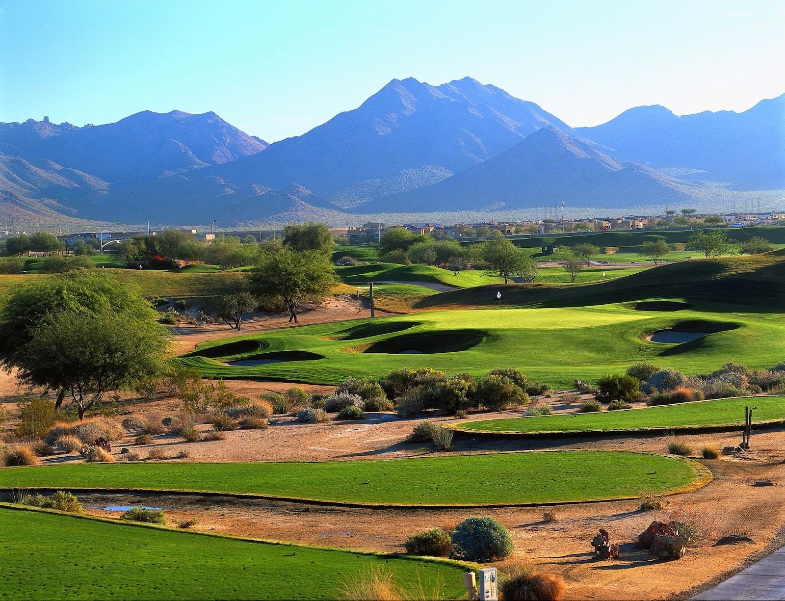 Desert golf in the Valley of the Sun, green fairways against saguaro and the McDowell Mountains near Scottsdale