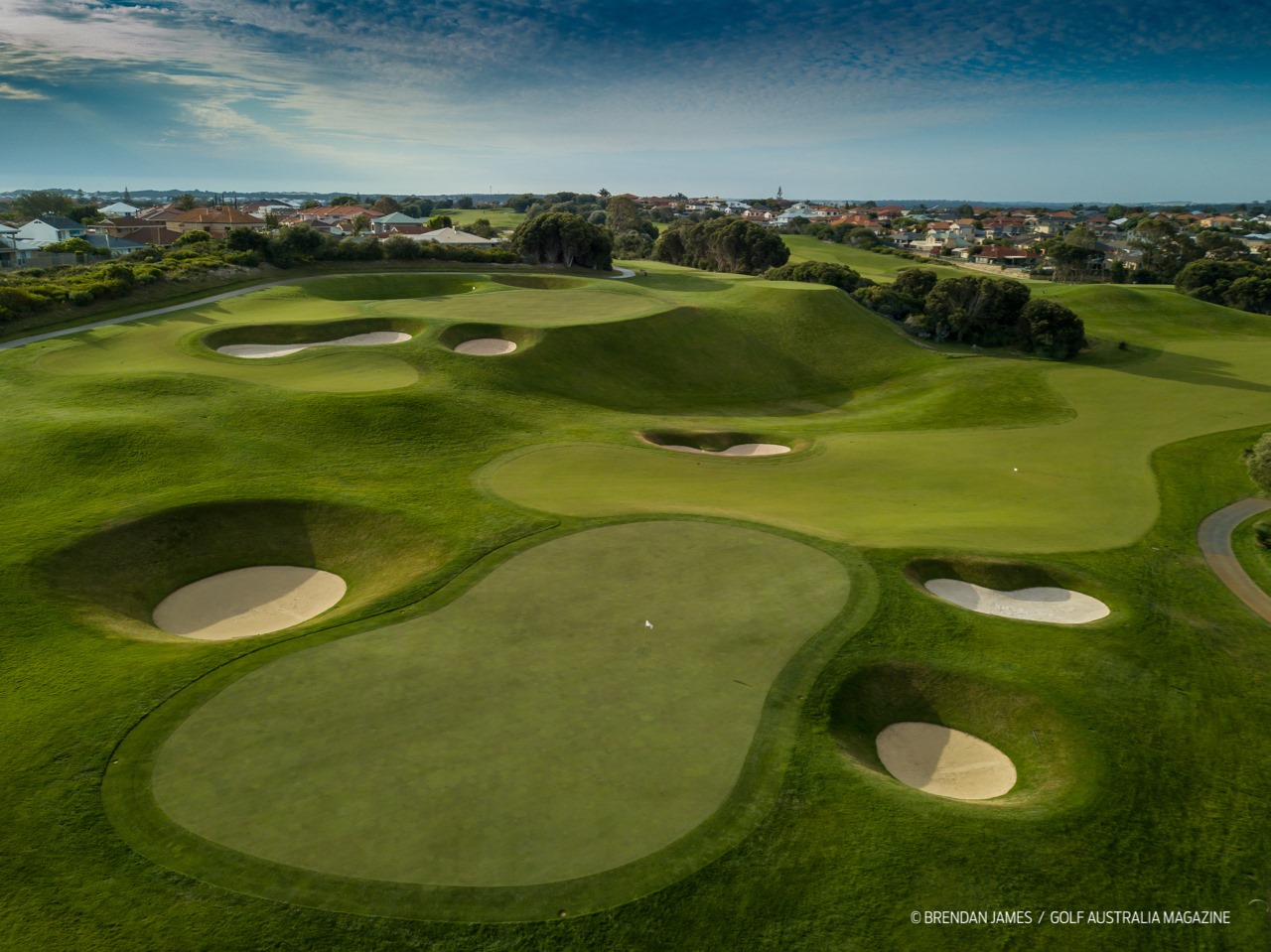Joondalup Resort golf course, Perth, fairways cut through bushland and limestone quarry walls