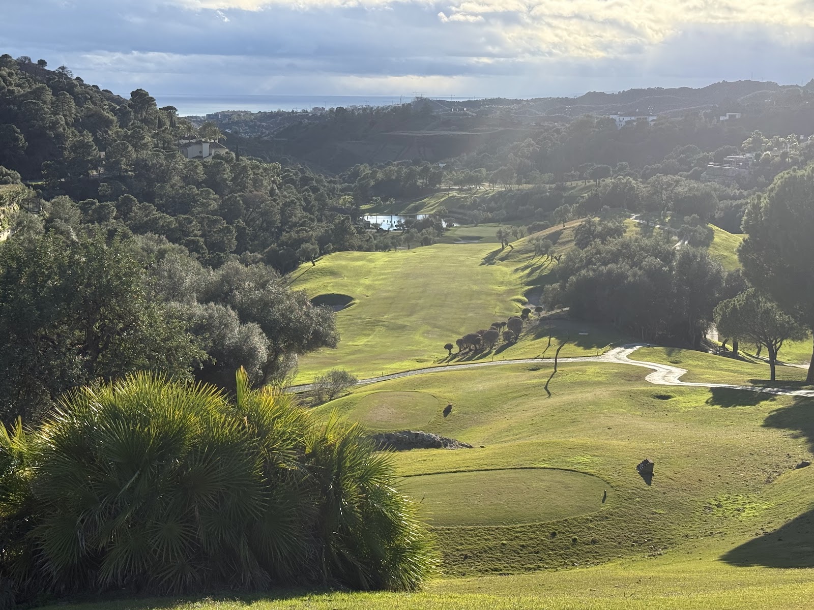 Marbella golf resort, fairway framed by mountains and Mediterranean on the Costa del Sol, Spain
