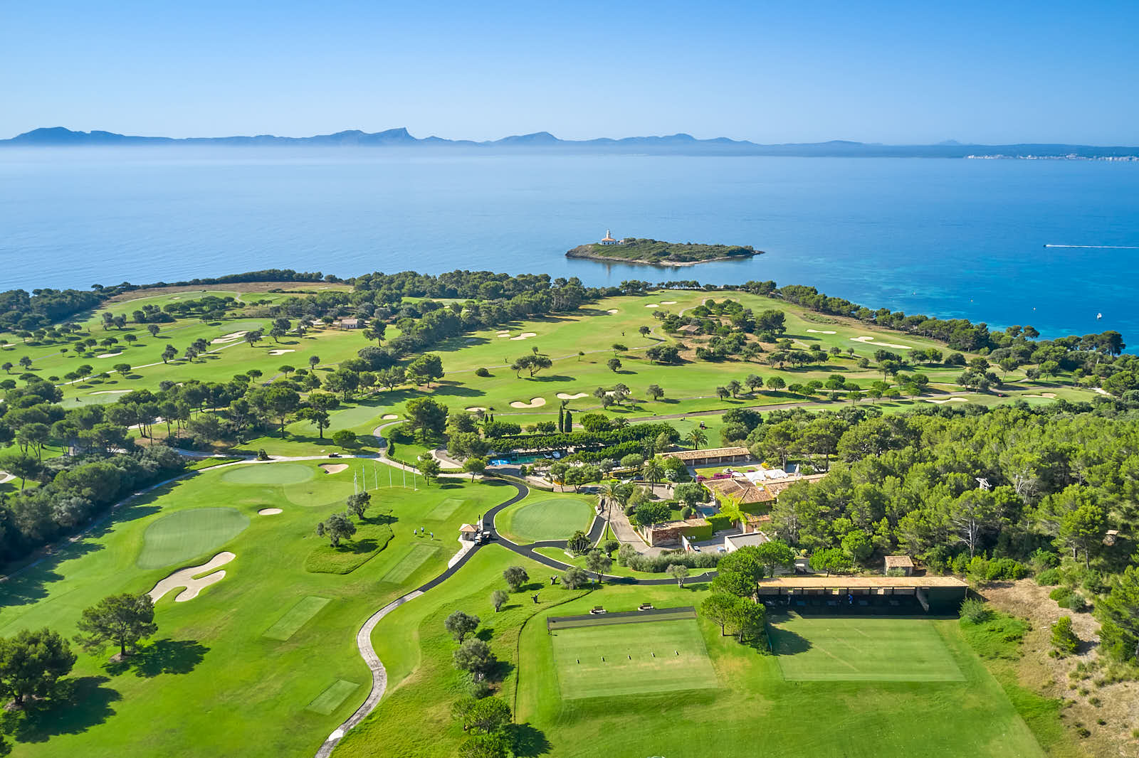 Club de Golf Alcanada, fairway and lighthouse on the Bay of Alcudia, Mallorca, Spain